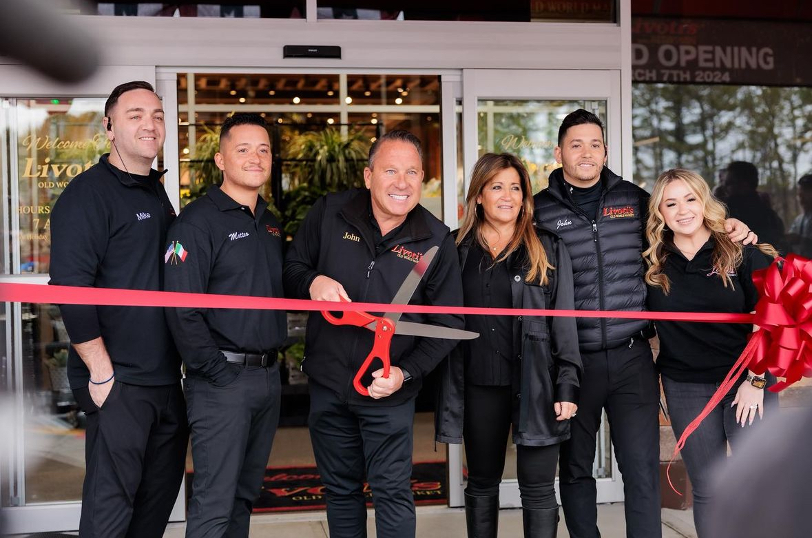Livoti's Old World Market family cutting a red ribbon to open the newest grocery store location
