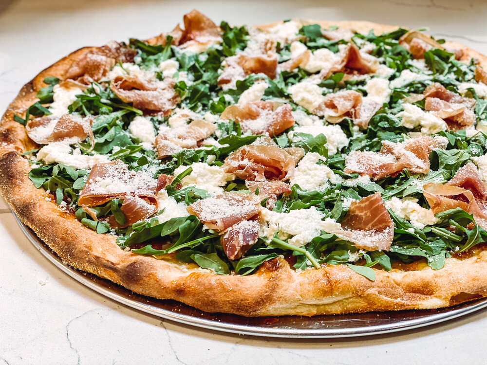 Freshly made pizza with prosciutto and cheese from Livoti's Old World Market