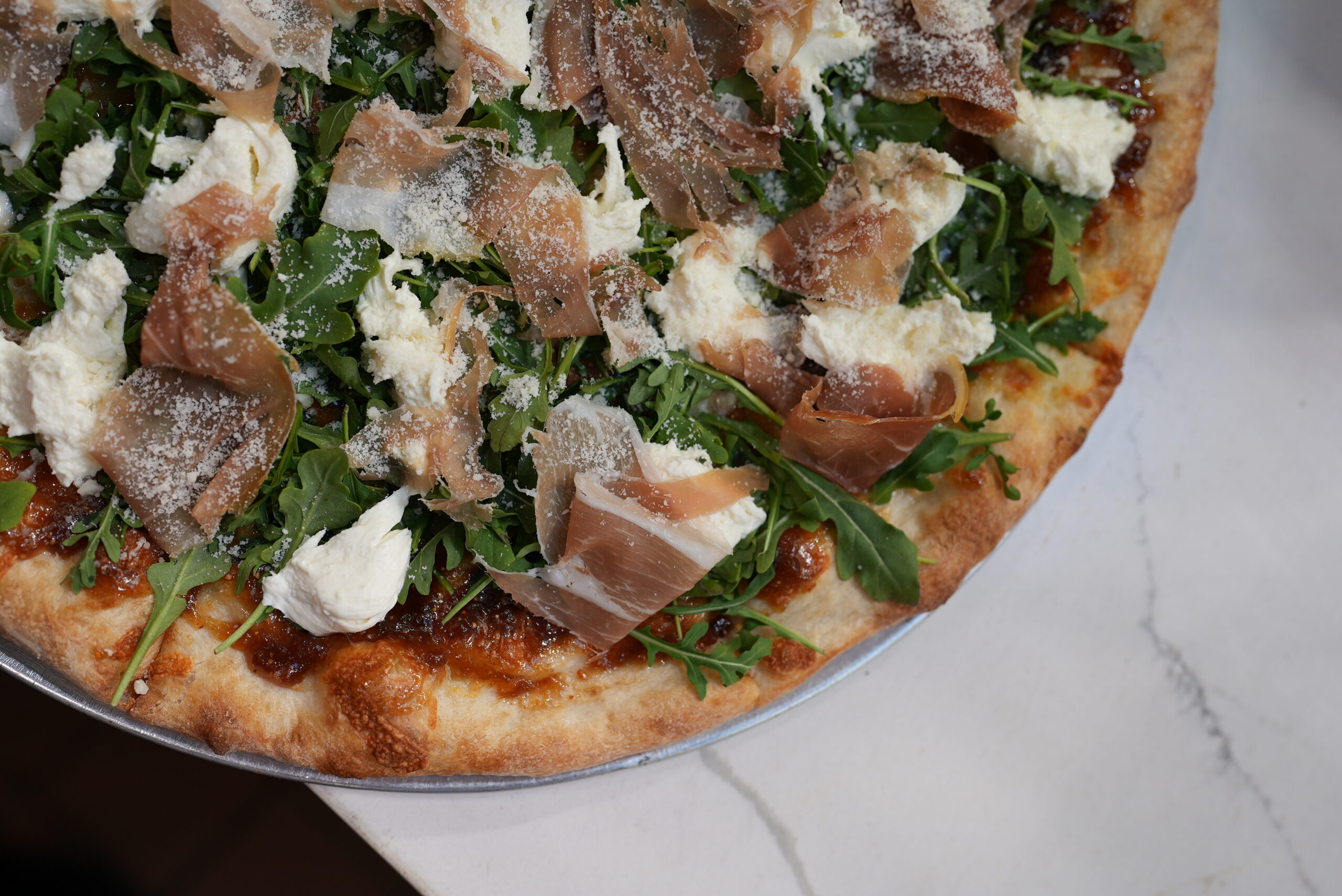 Brick oven pizza from Livoti's Old World Market with prosciutto and cheese