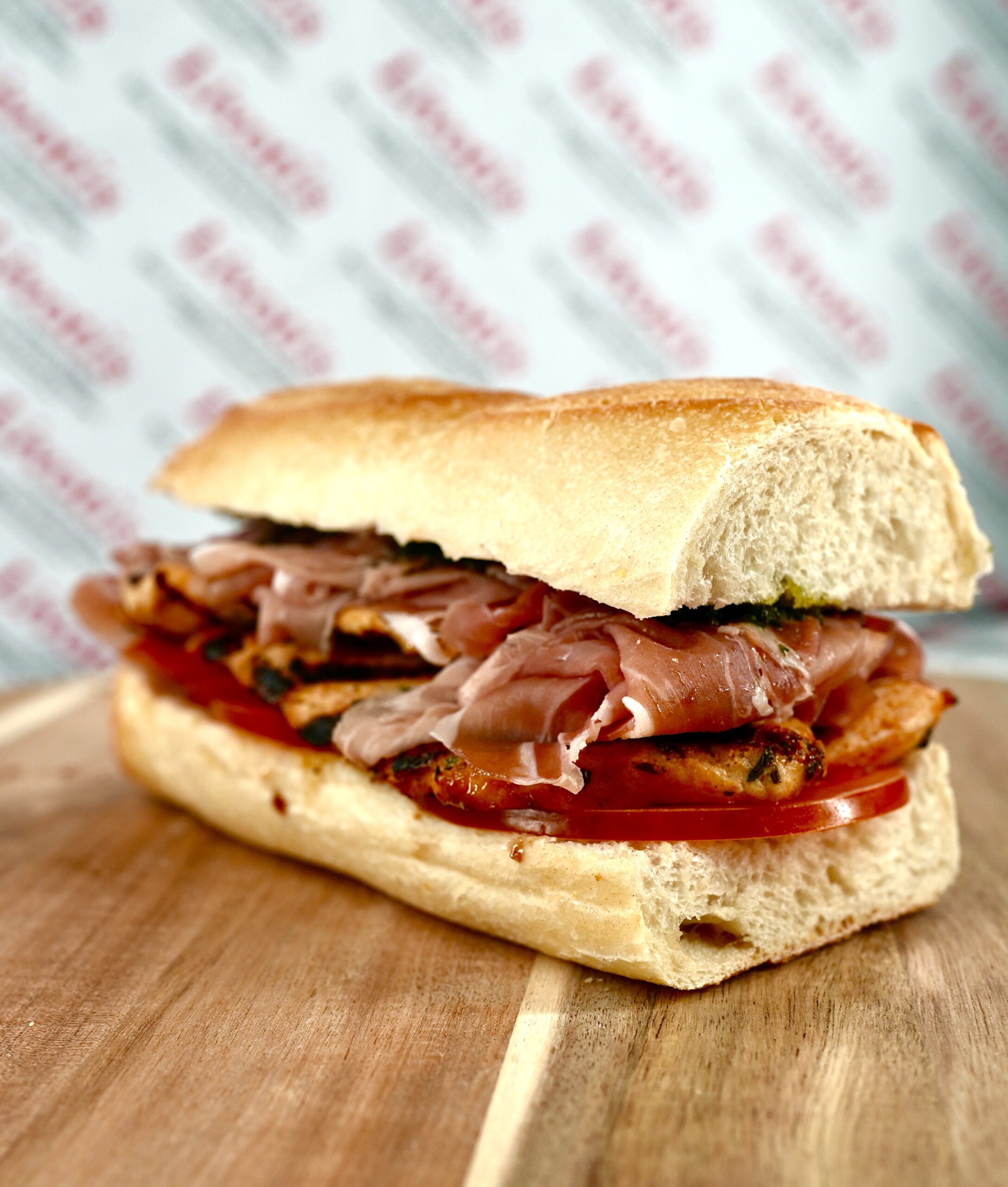 Deli sandwich with prosciutto, chicken, and tomato prepared by Livoti's Old World Market