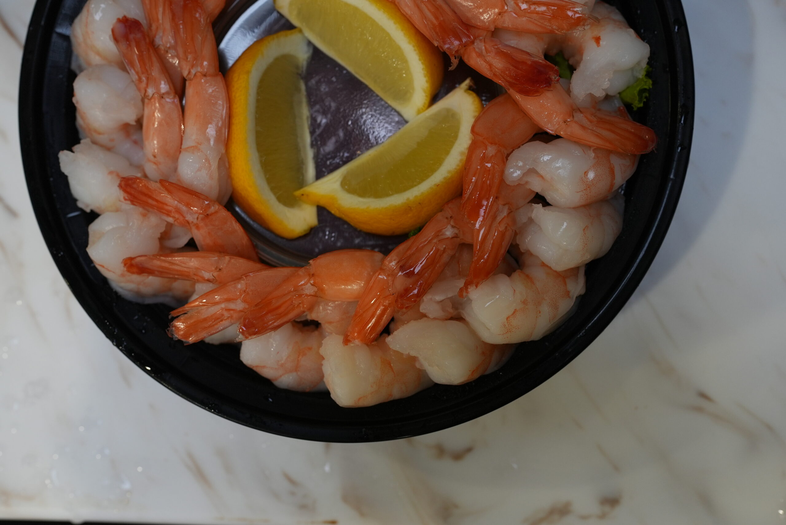 Small shrimp cocktail platter with lemon wedges
